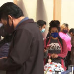 people standing on line for food in California